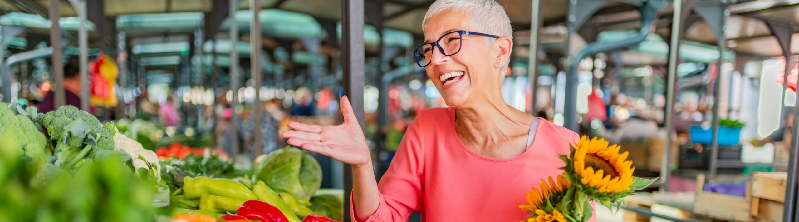 Smiling woman buying flowers.