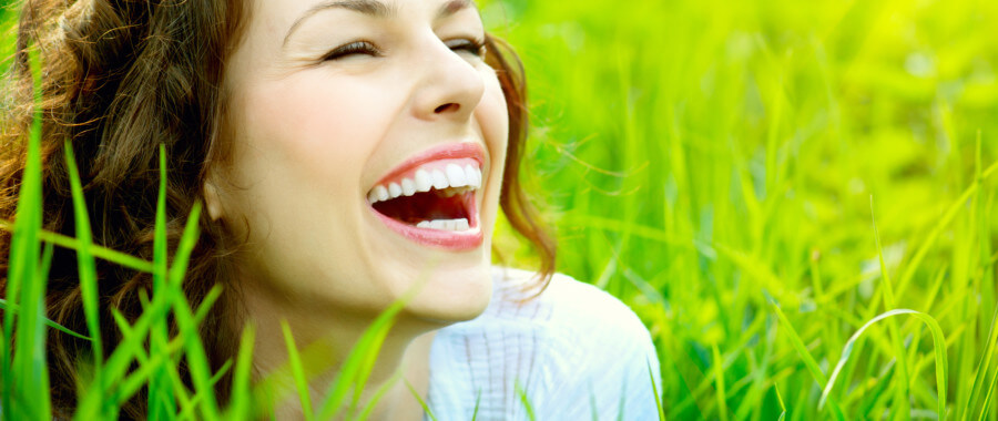 healthy woman smiling in grass