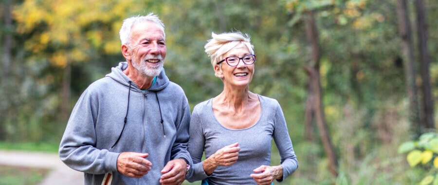 Senior couple exercising outdoors to treat arthritis the functional medicine way.