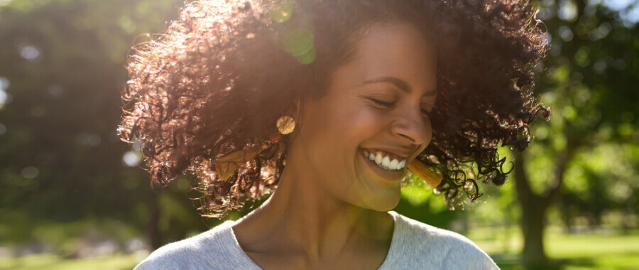woman happy outside curly hair