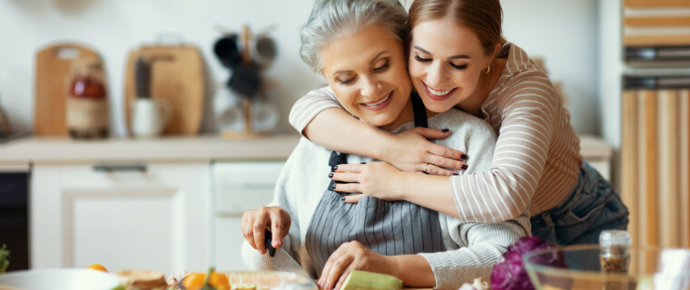 Two women cooking in the kitchen.