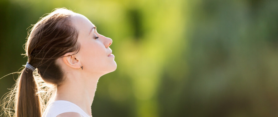Woman at peace enjoys the outdoors.