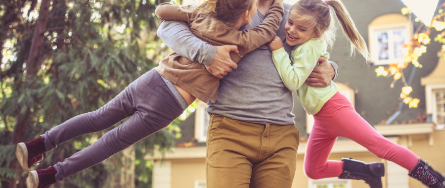 happy dad picking up daughters