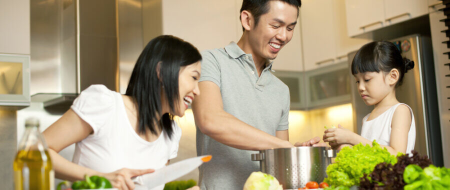 a family prepares food in a kitchen