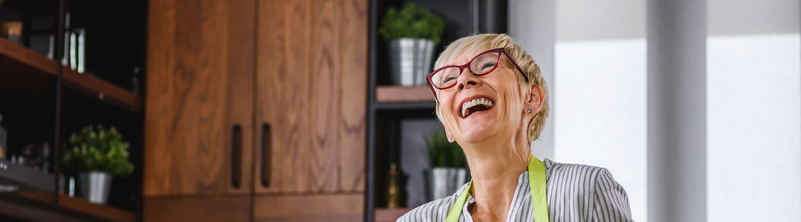 Older woman in the kitchen.